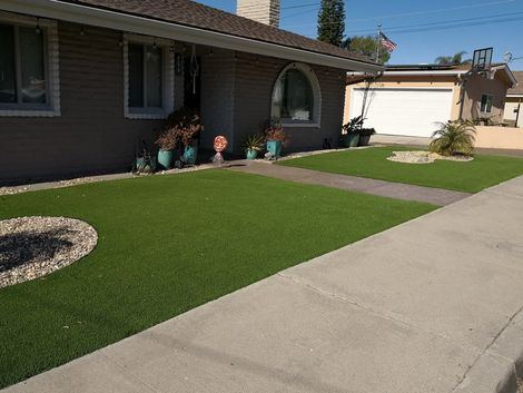 front yard made of artificial turf and pavers