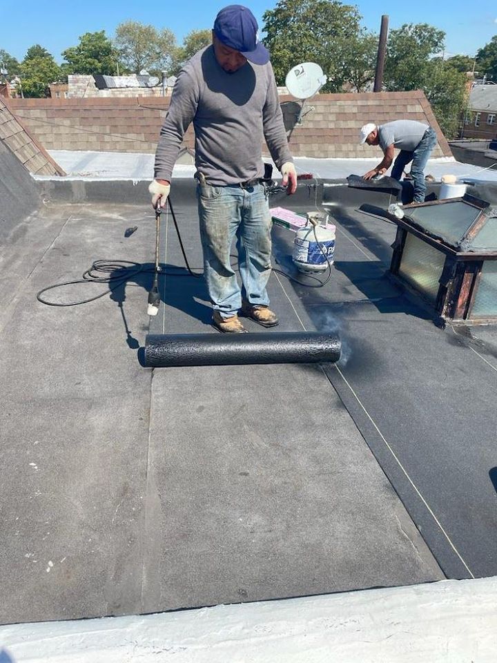 2 men installing concrete roofing