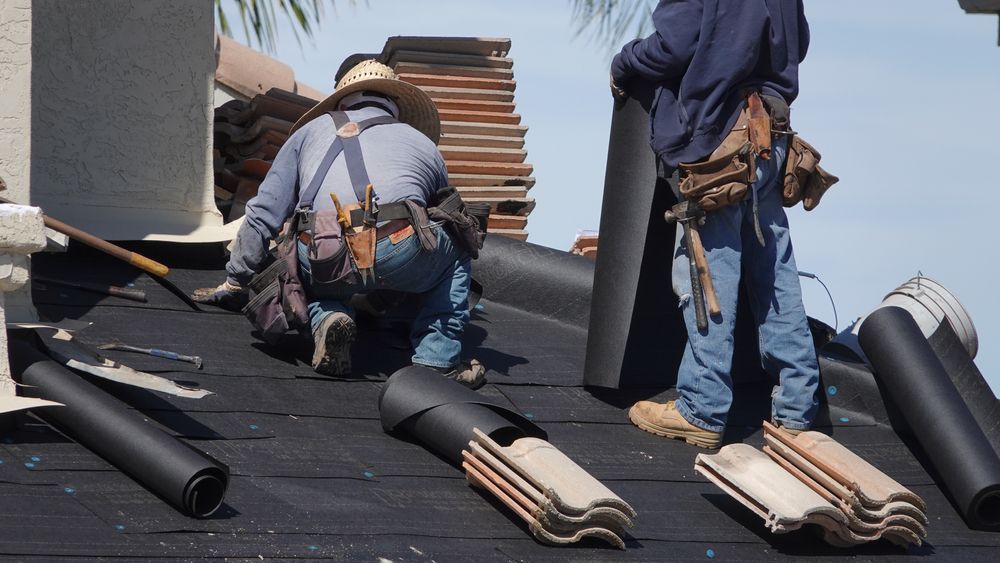 workers install tile roof