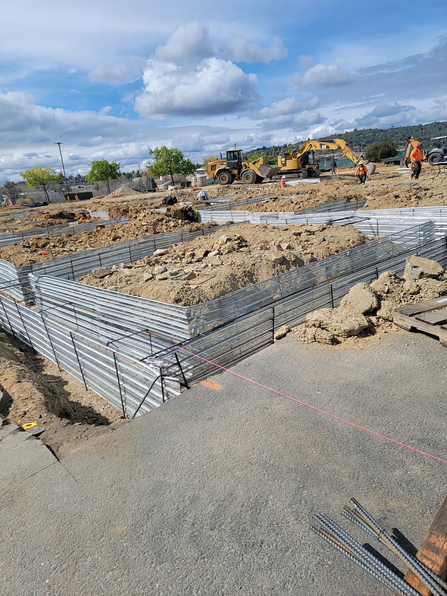 A construction site with a lot of dirt and machinery.