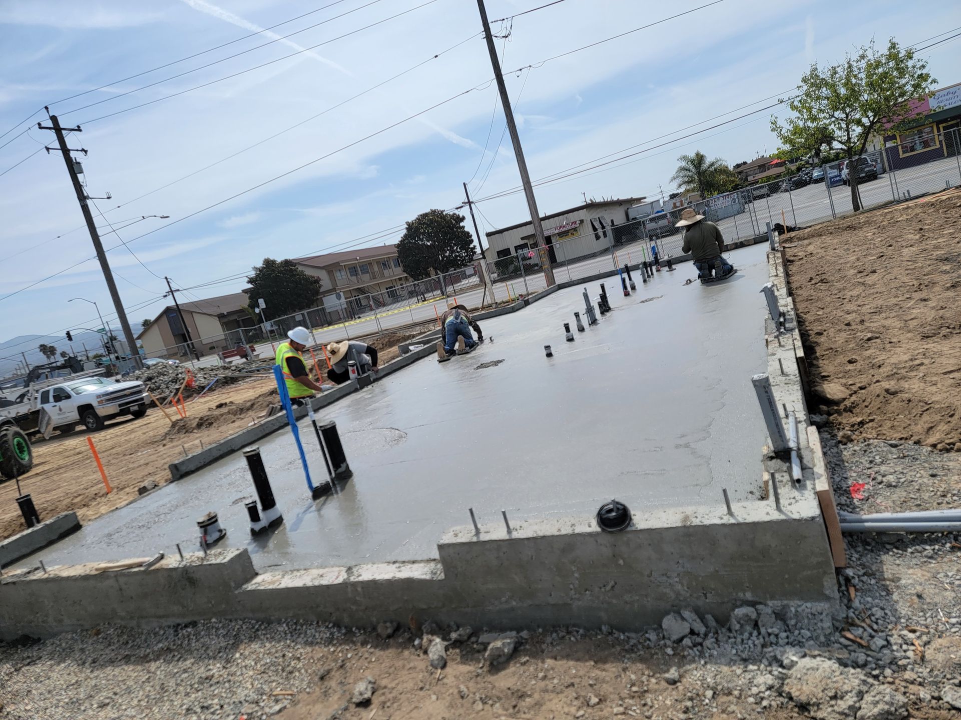 A group of construction workers are working on a concrete floor.