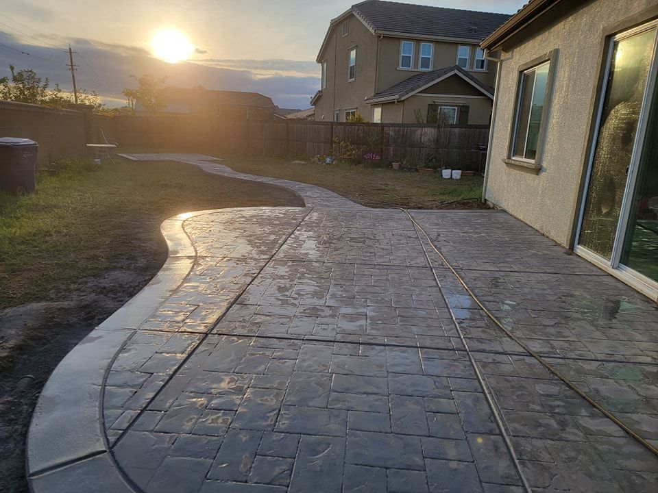A concrete walkway leading to the front door of a house.