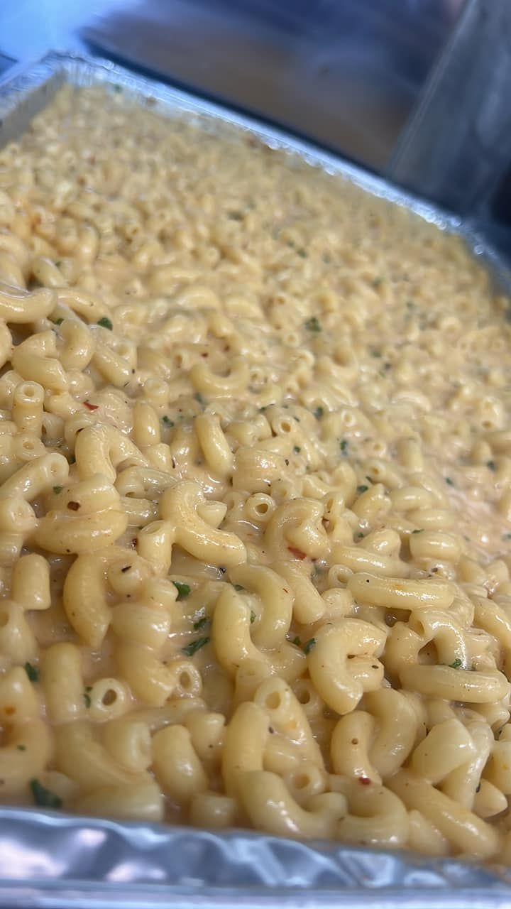 a tray of macaroni and cheese is sitting on a table .