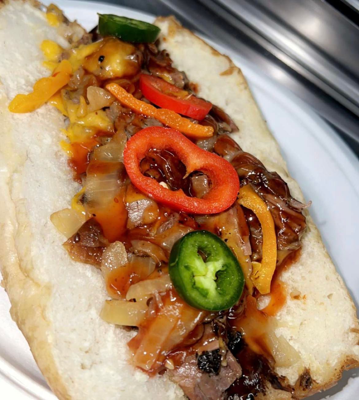 a close up of a hot dog on a white plate