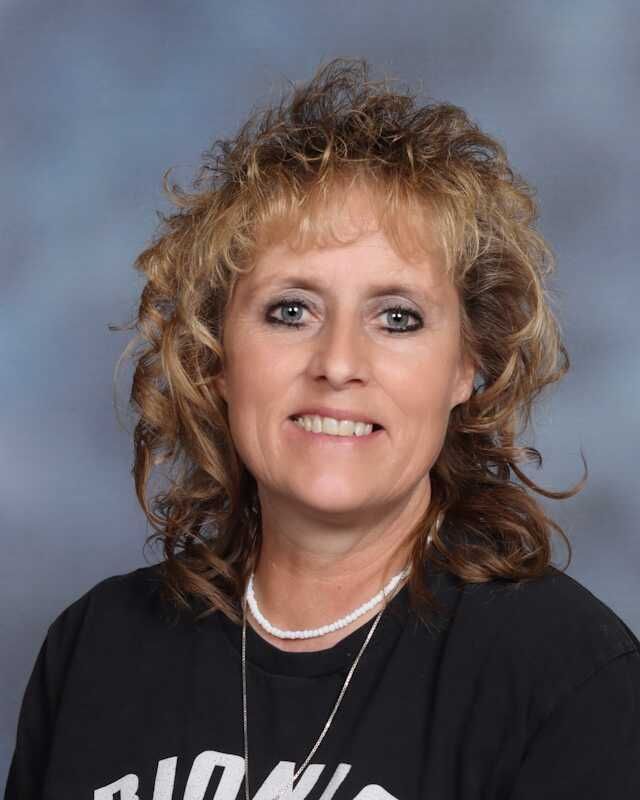 A woman wearing a black shirt with the word lions on it