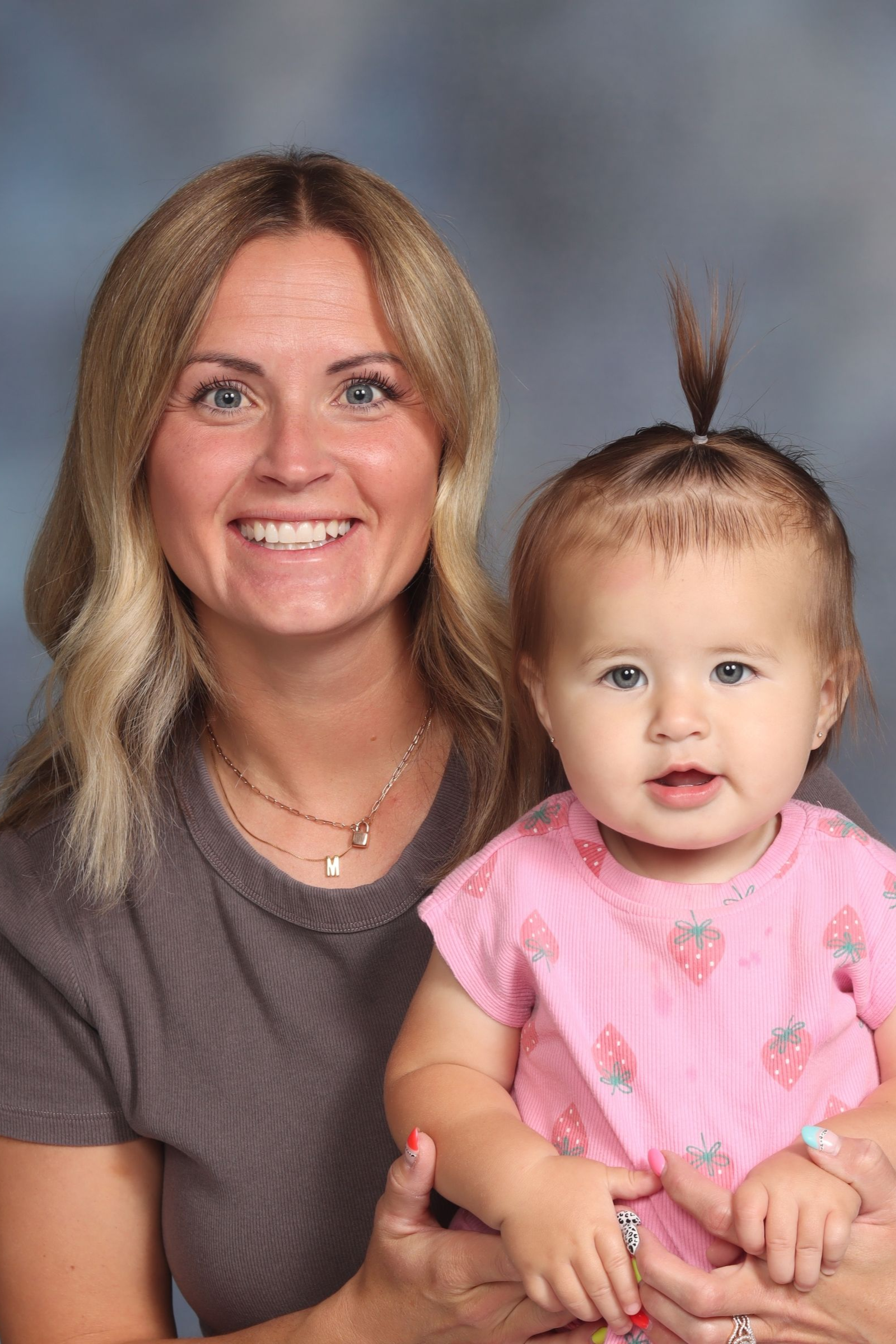 A woman in a striped shirt is smiling for the camera.