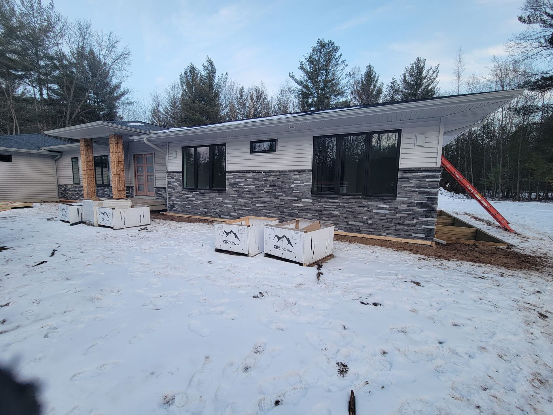A house is being built in the snow.