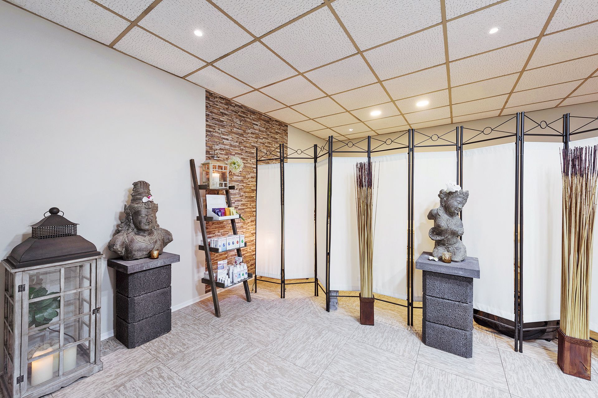 Ein Raum mit einer Leiter, Kerzen, Statuen und einer Bärenstatue.