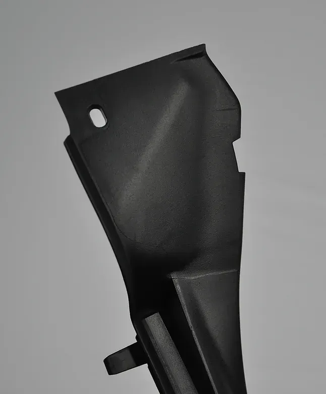 Black plastic car interior trim with a rectangular hole.