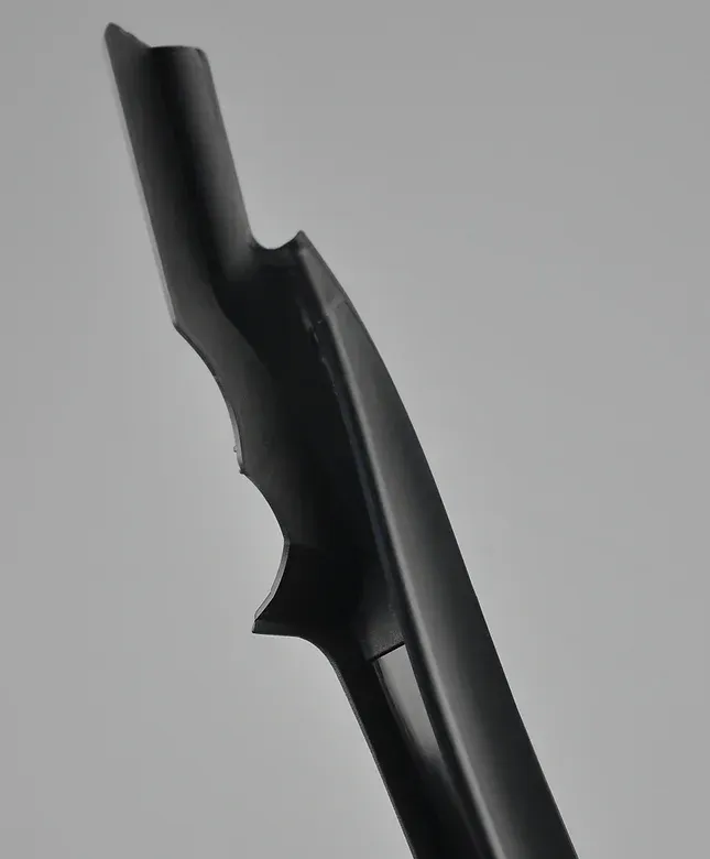 Black, curved car part with a textured grip.