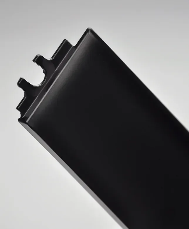 Black aluminum extrusion profile with a curved channel.