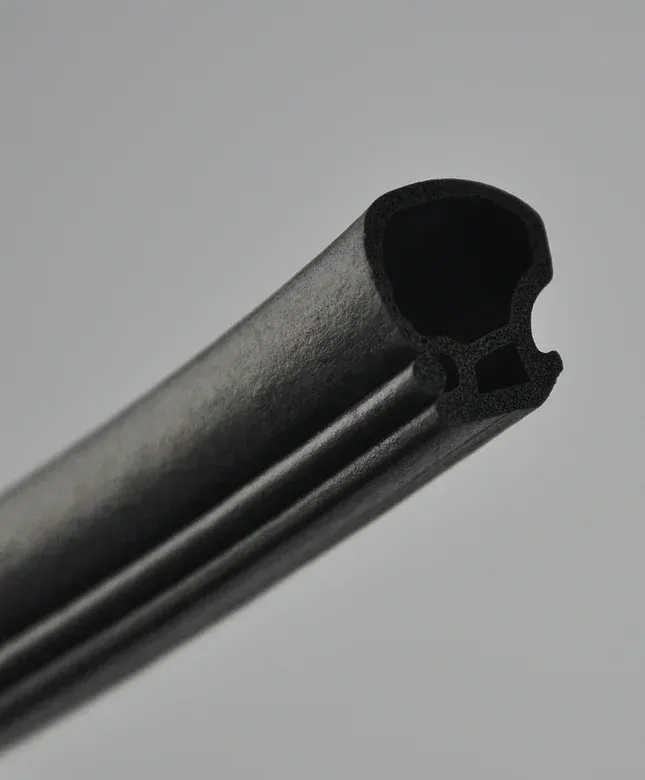 Black rubber seal with a hollow interior and a grooved exterior.