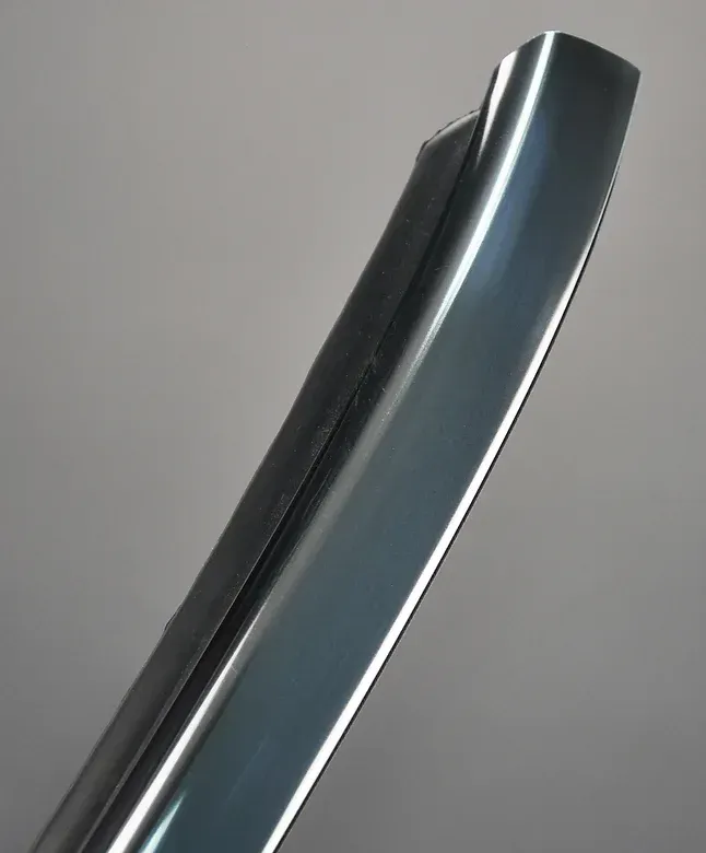 Close-up of a teal-colored car door molding with a rubber strip attached.