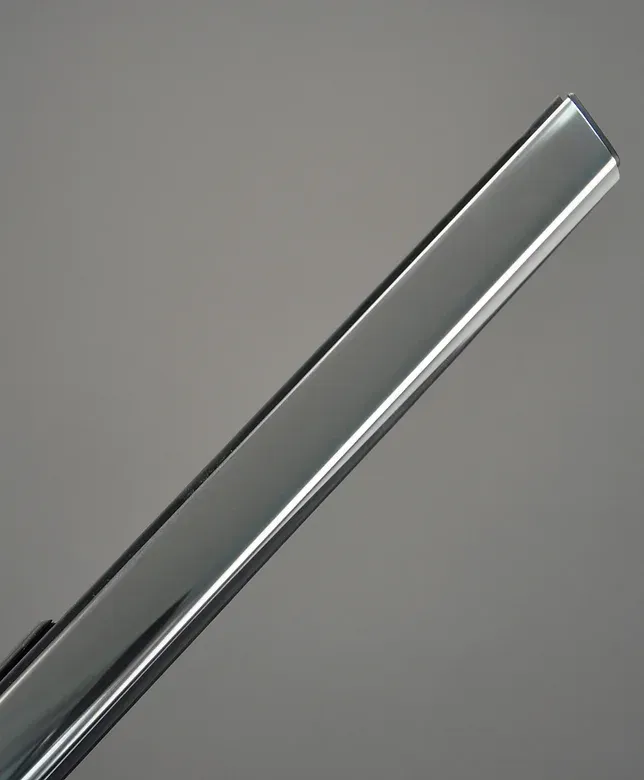 Shiny, rectangular chrome bar, angled across a gray background.
