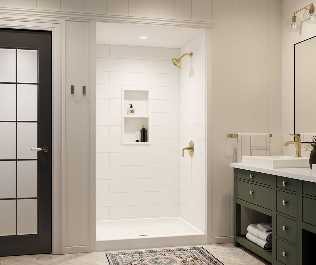 Modern bathroom with white tiled shower, black door, and dark green vanity with brass fixtures