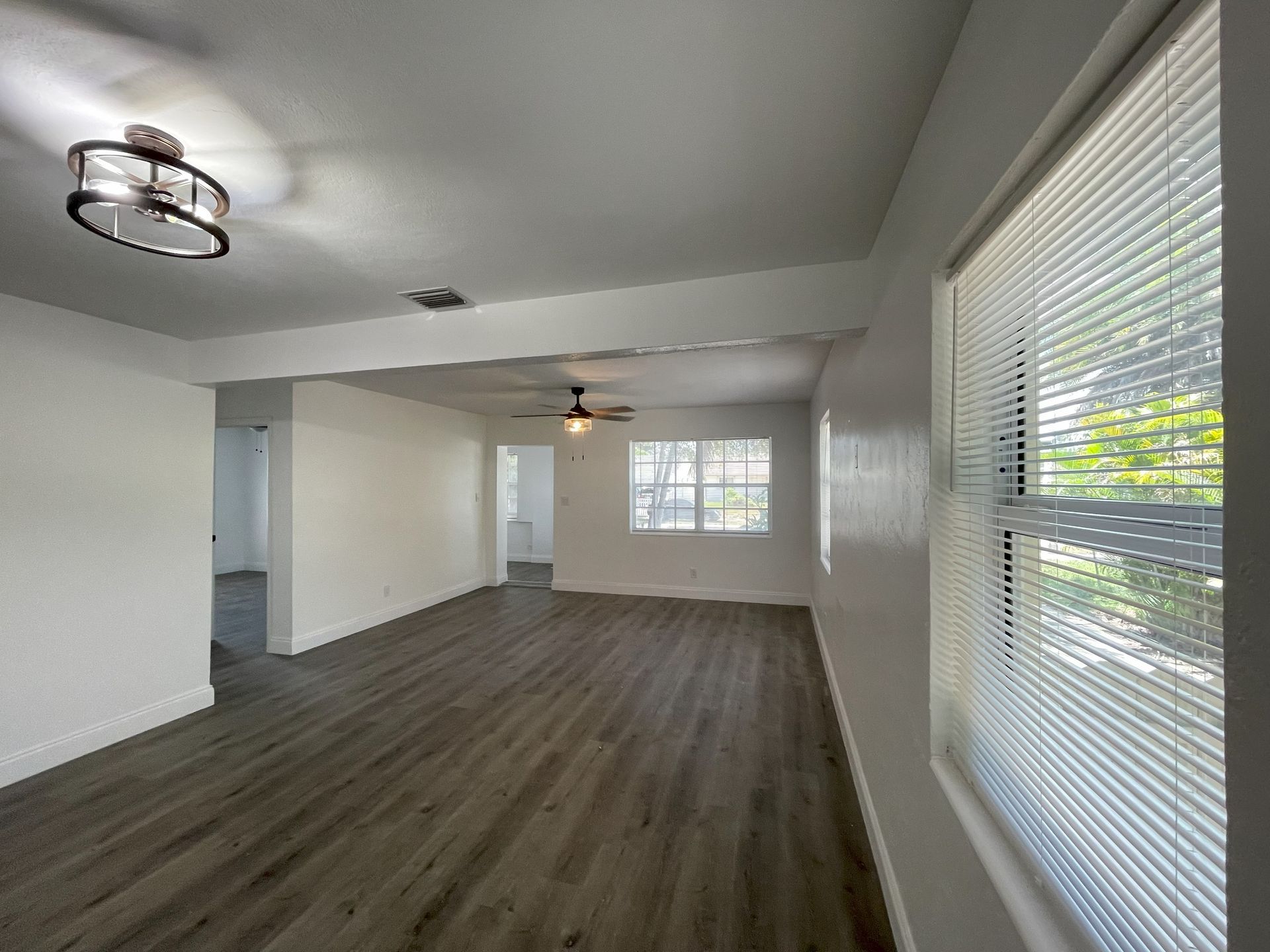 Living room with gray flooring, white walls.