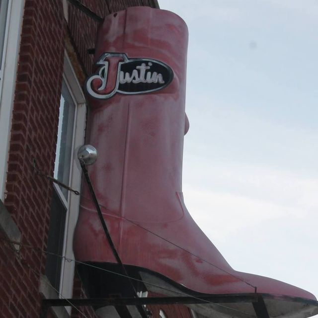 A pink cowboy boot with the word justin on it