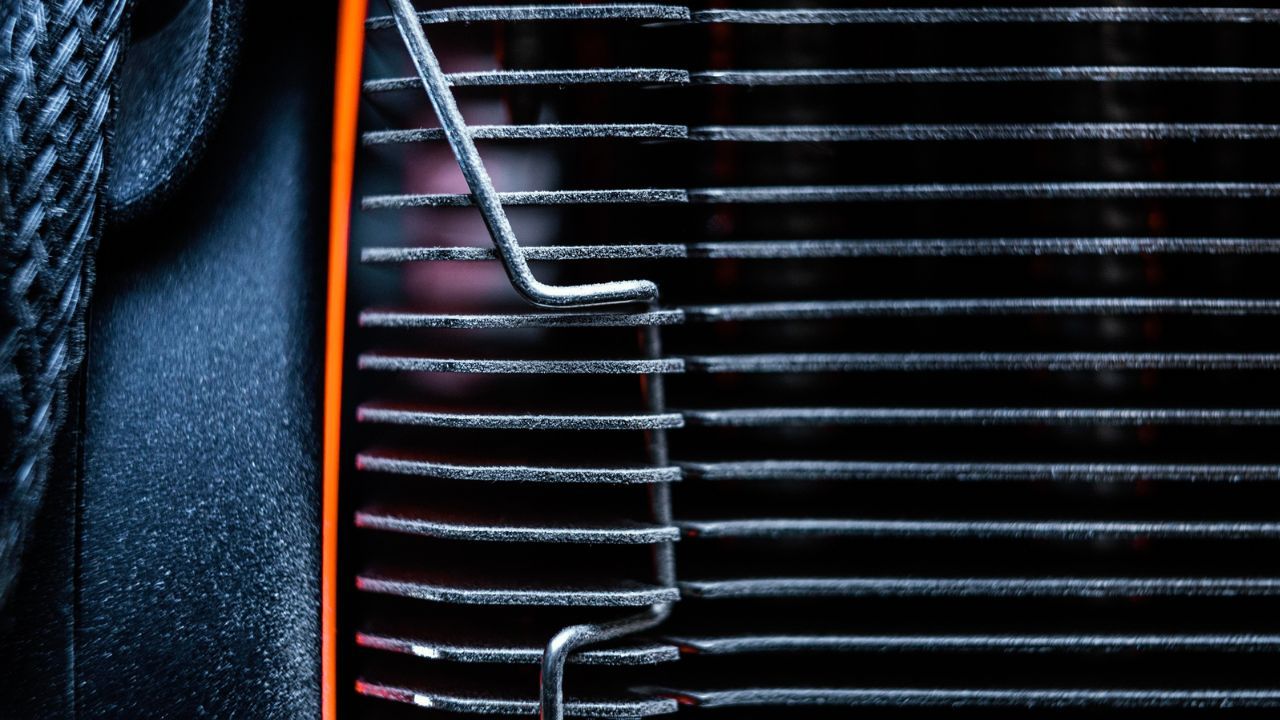 Close-up of car radiator fins showing cooling system detail
