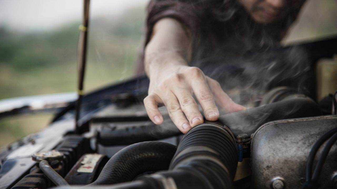  Car engine problem showing heat and smoke under hood
