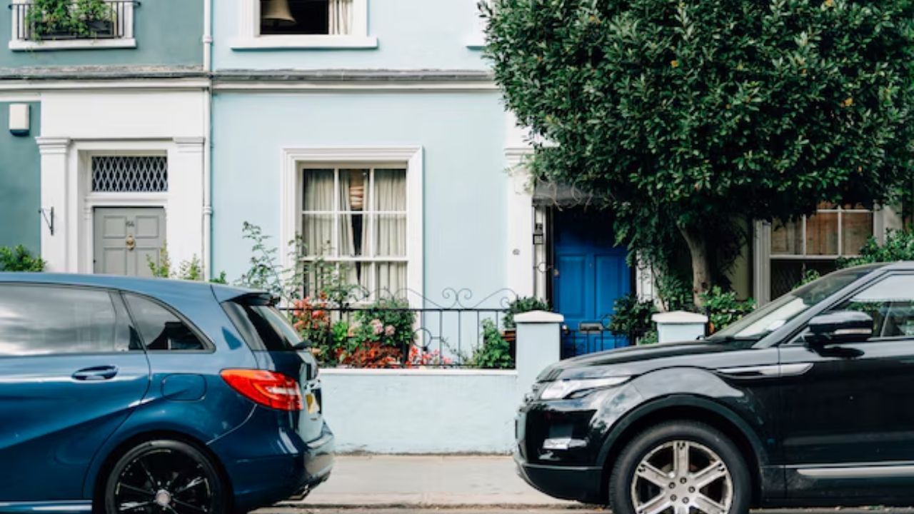 Cars parked near buildings and trees to keep the car cool.