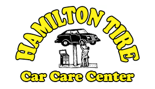 Logo for Hamilton Tire Car Care Center, with car on lift being serviced. Yellow lettering on white background.