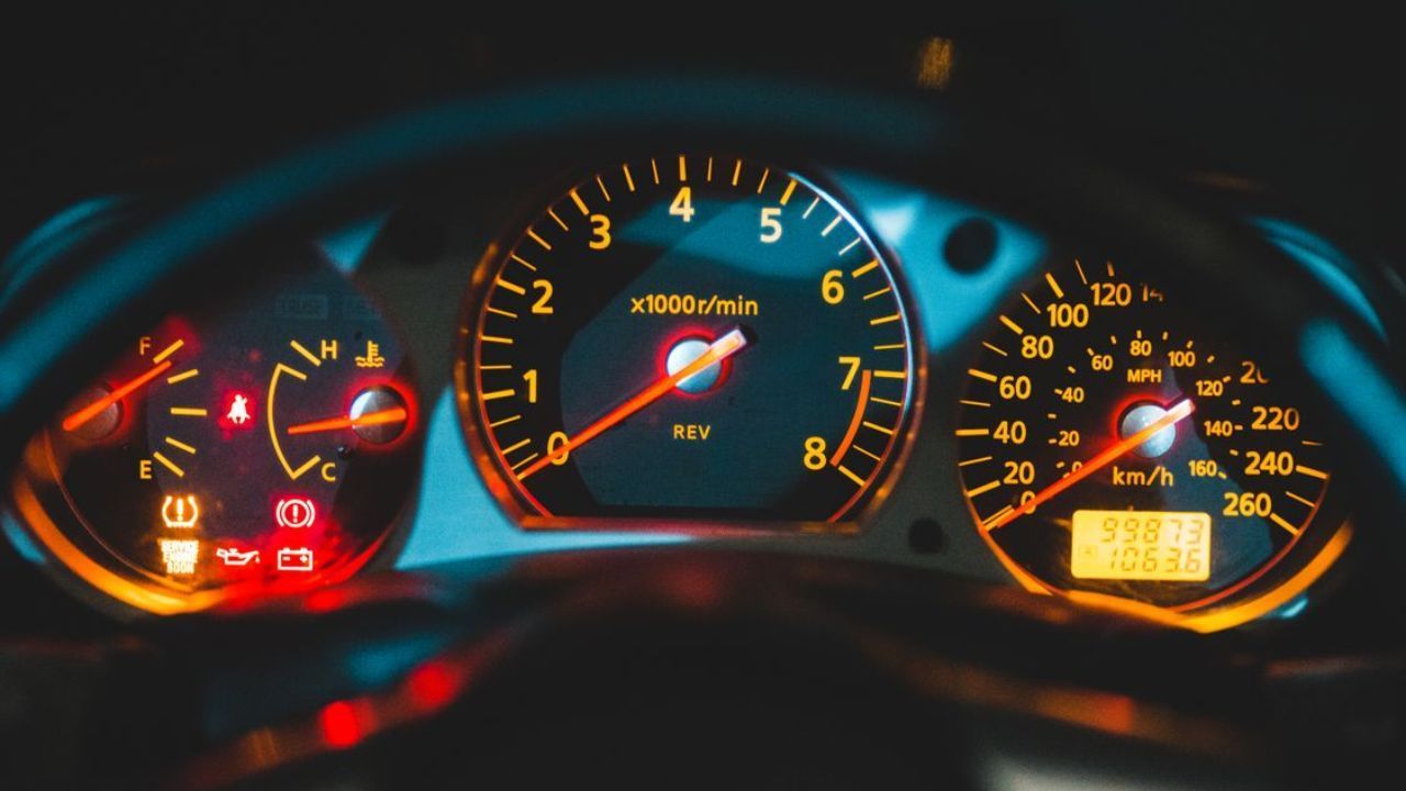 Vehicle instrument panel with illuminated warning indicators and tire pressure light
