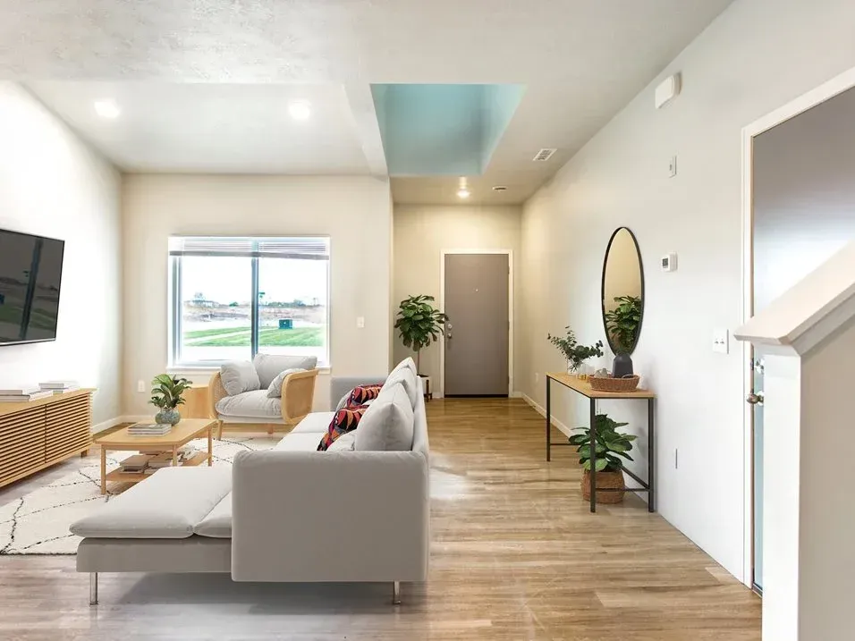 A living room with a couch , chair , table and television.