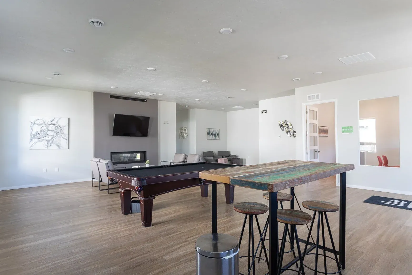There is a pool table in the middle of the room.
