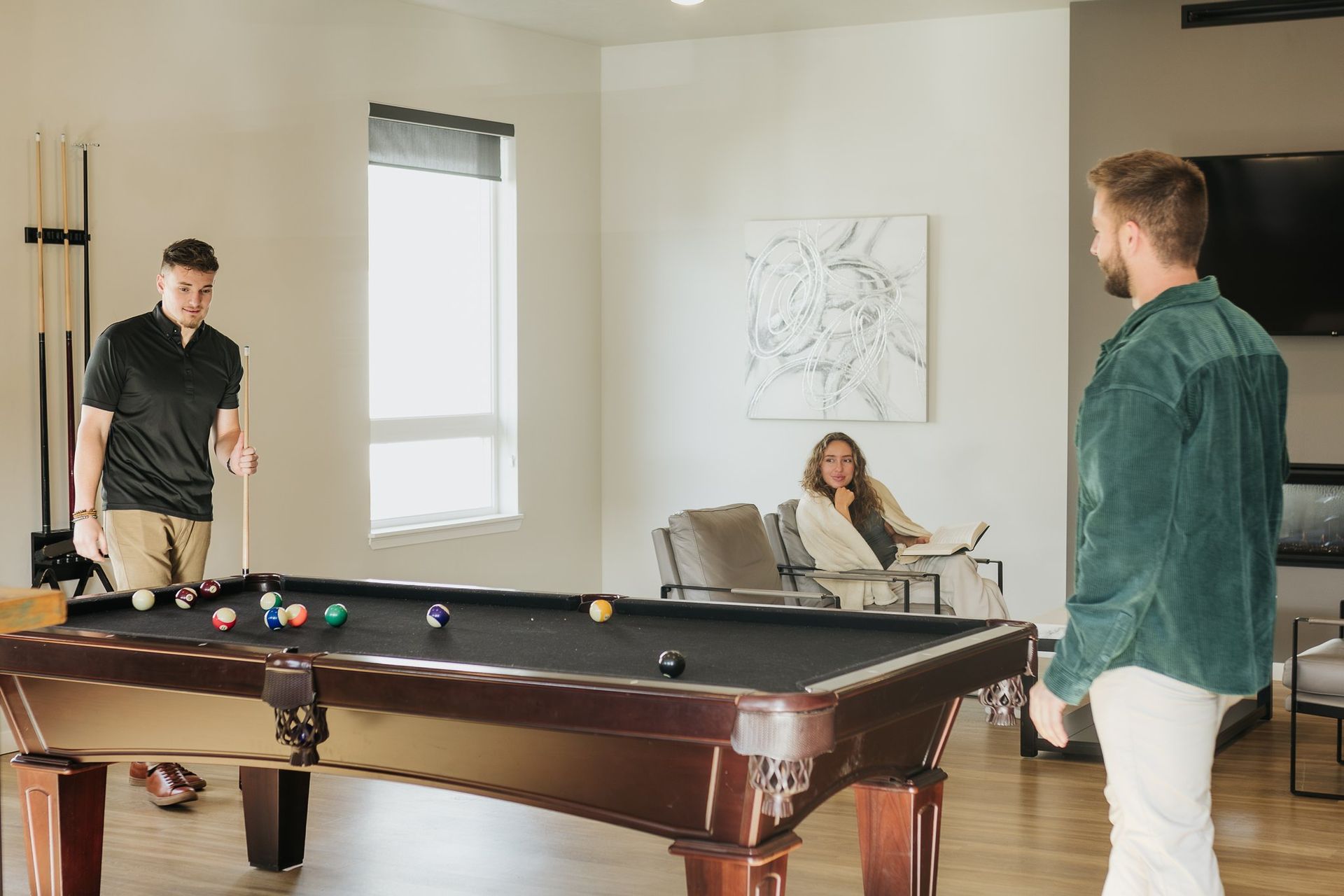 People playing pool in the clubhouse.