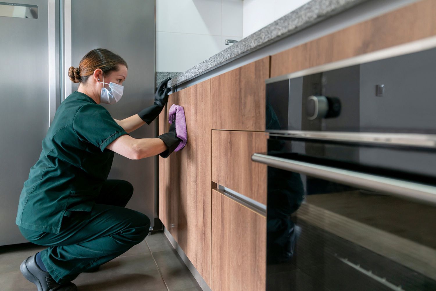 Cleaning cart in a brightly lit hallway with closed doors.