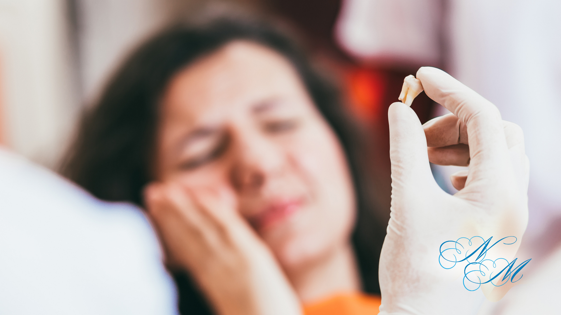 Gloved hand holding a tiny dropper over a blurred person receiving a facial treatment