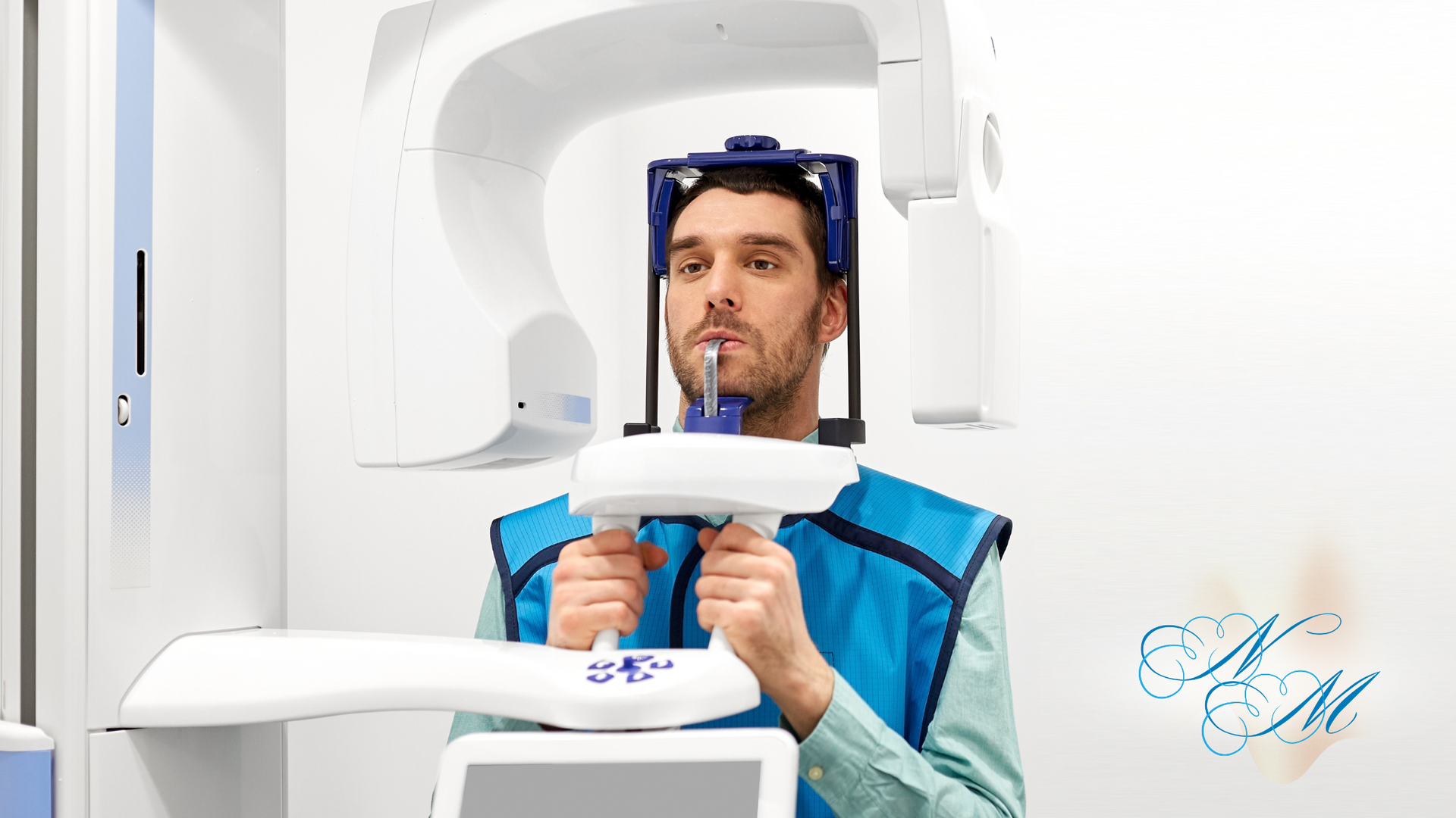 A man is getting an x-ray of his teeth in a dental office.