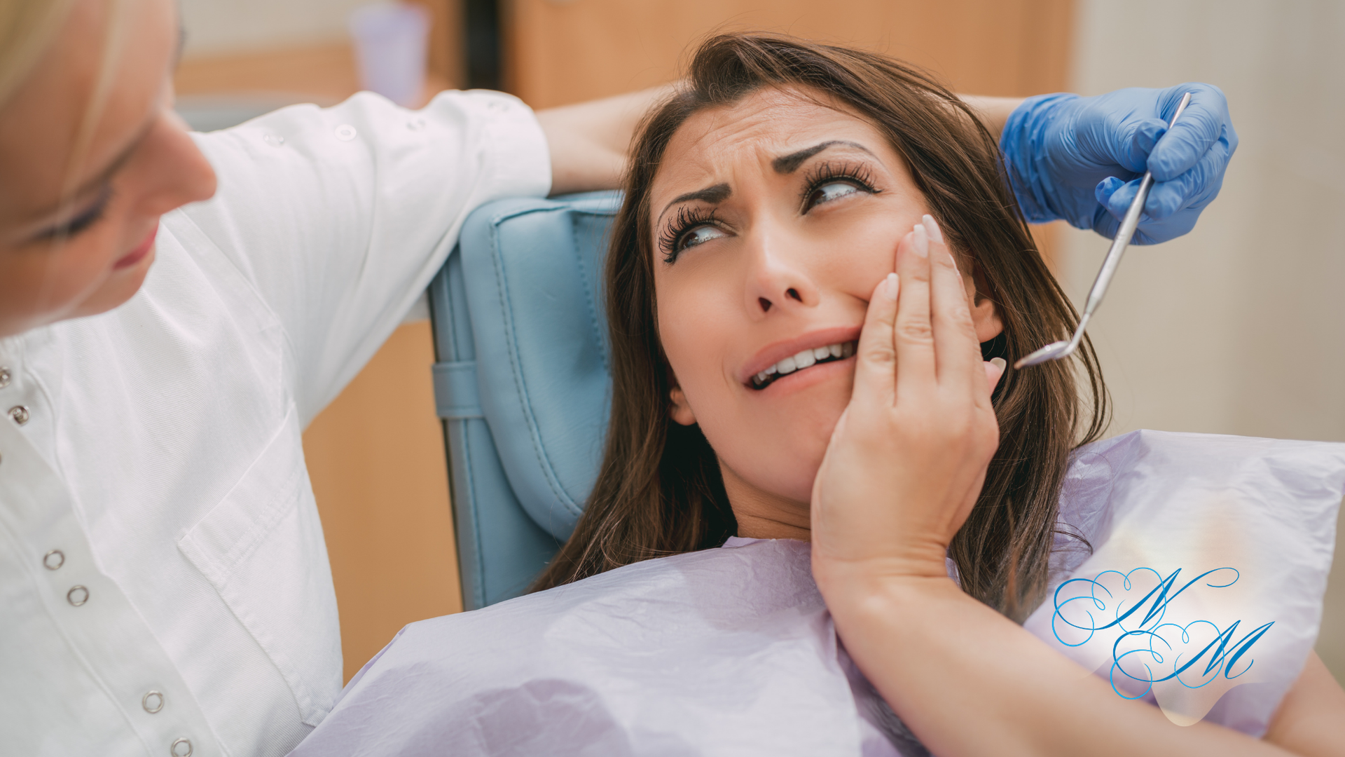 Woman holding face in pain, eyes closed, white tank top, light background.