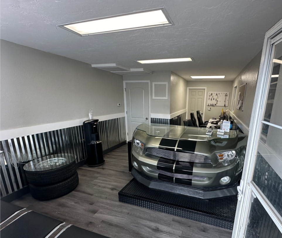 A car inside a repair shop with a silver and black color scheme | Jim's Auto Repair & Towing