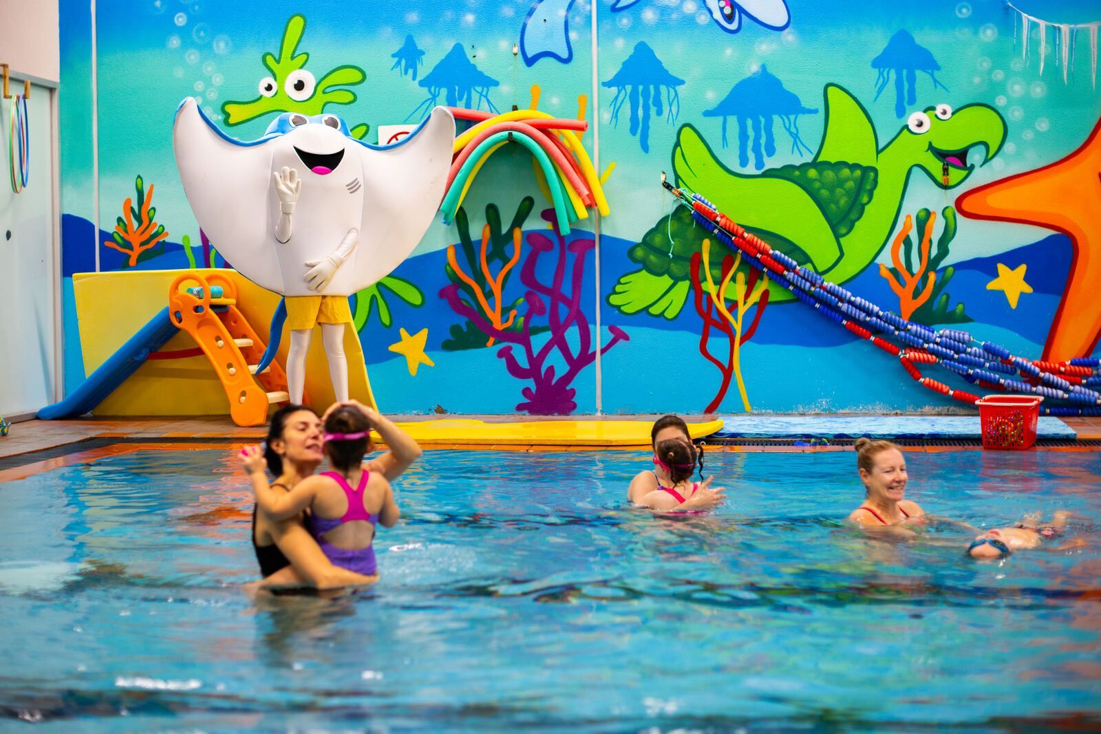 Parents and children in a swim lesson