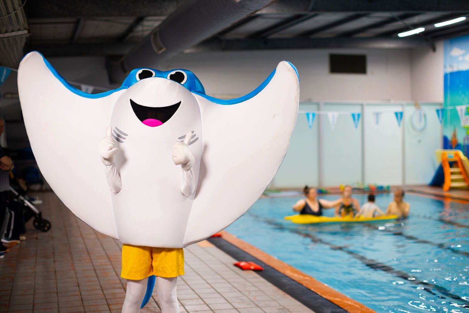 Shawn's Swim School stingray mascot by the pool