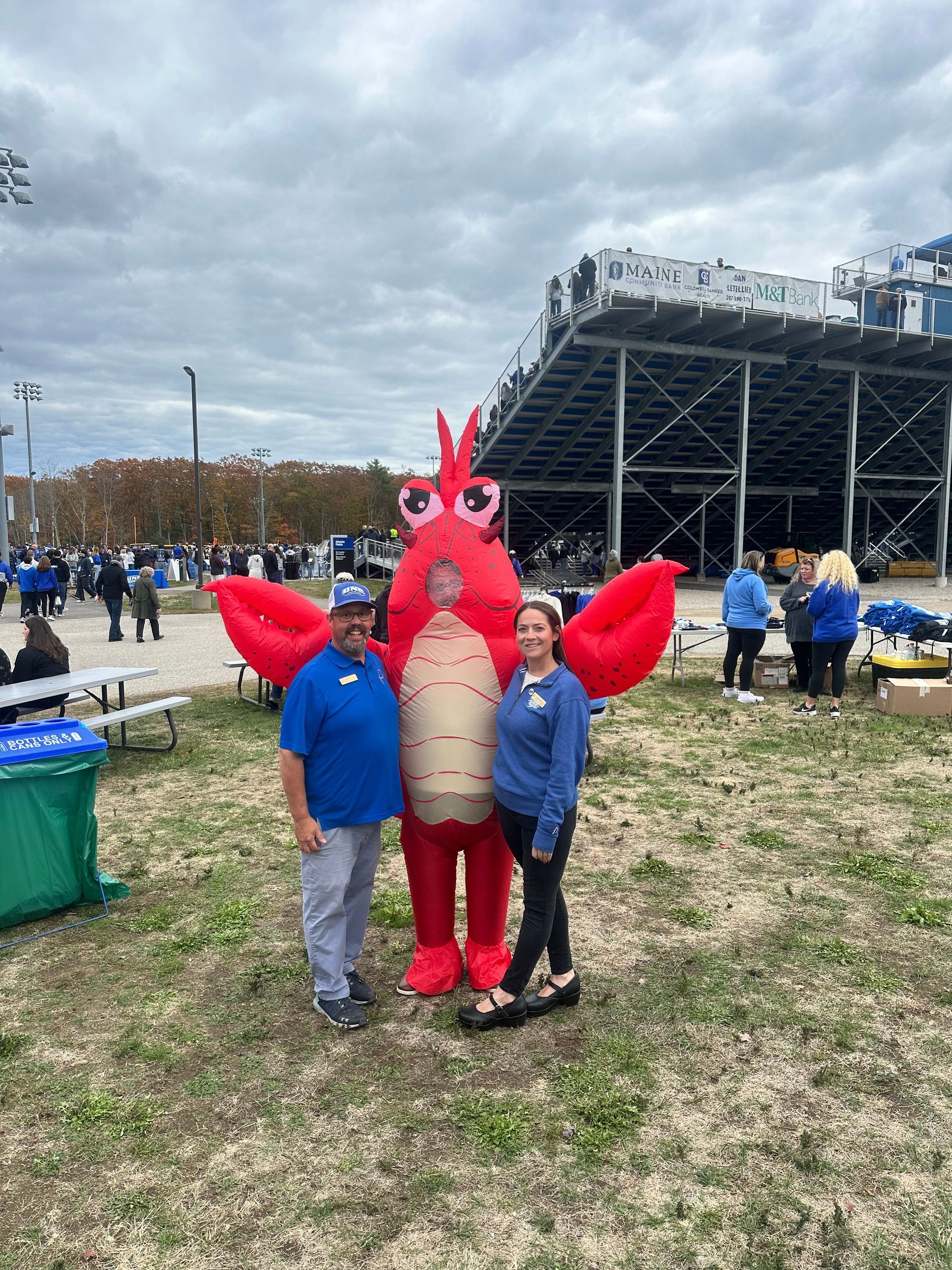 Group of people holding a large check in a hospital lobby. The check is made out to UNC Children's Hospital.