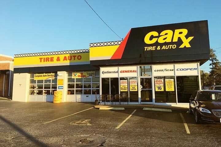 CarX Tire & Auto storefront with yellow and black signage, tires visible, and parked car.