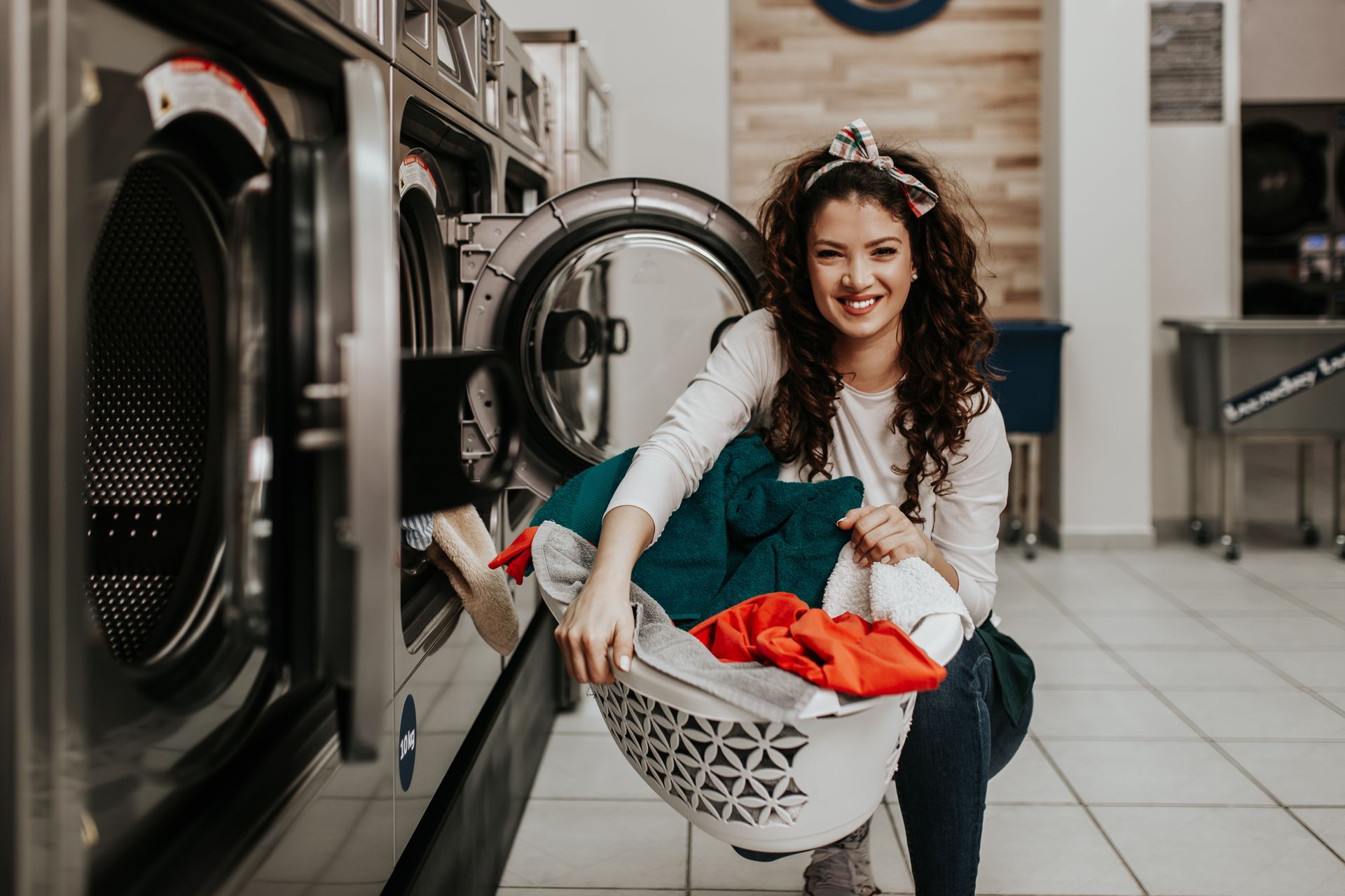 Holding laundry basket at laundromat