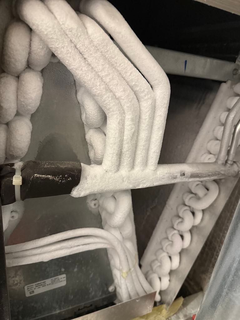 A close up of a pipe covered in ice.