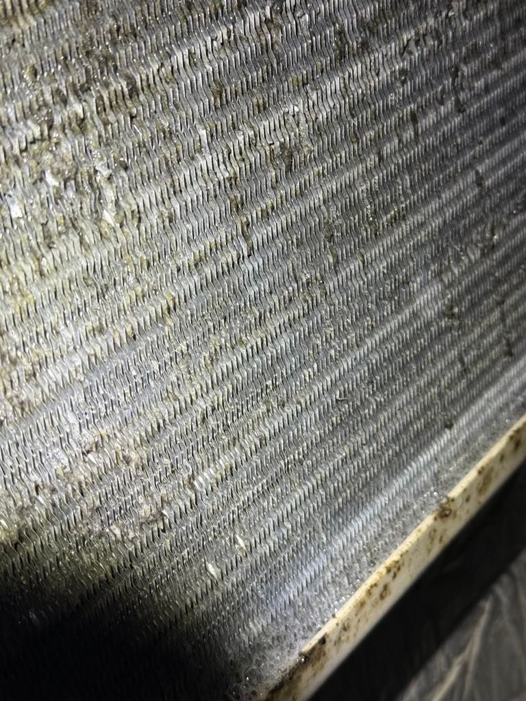 A close up of a metal surface with a lot of holes in it.