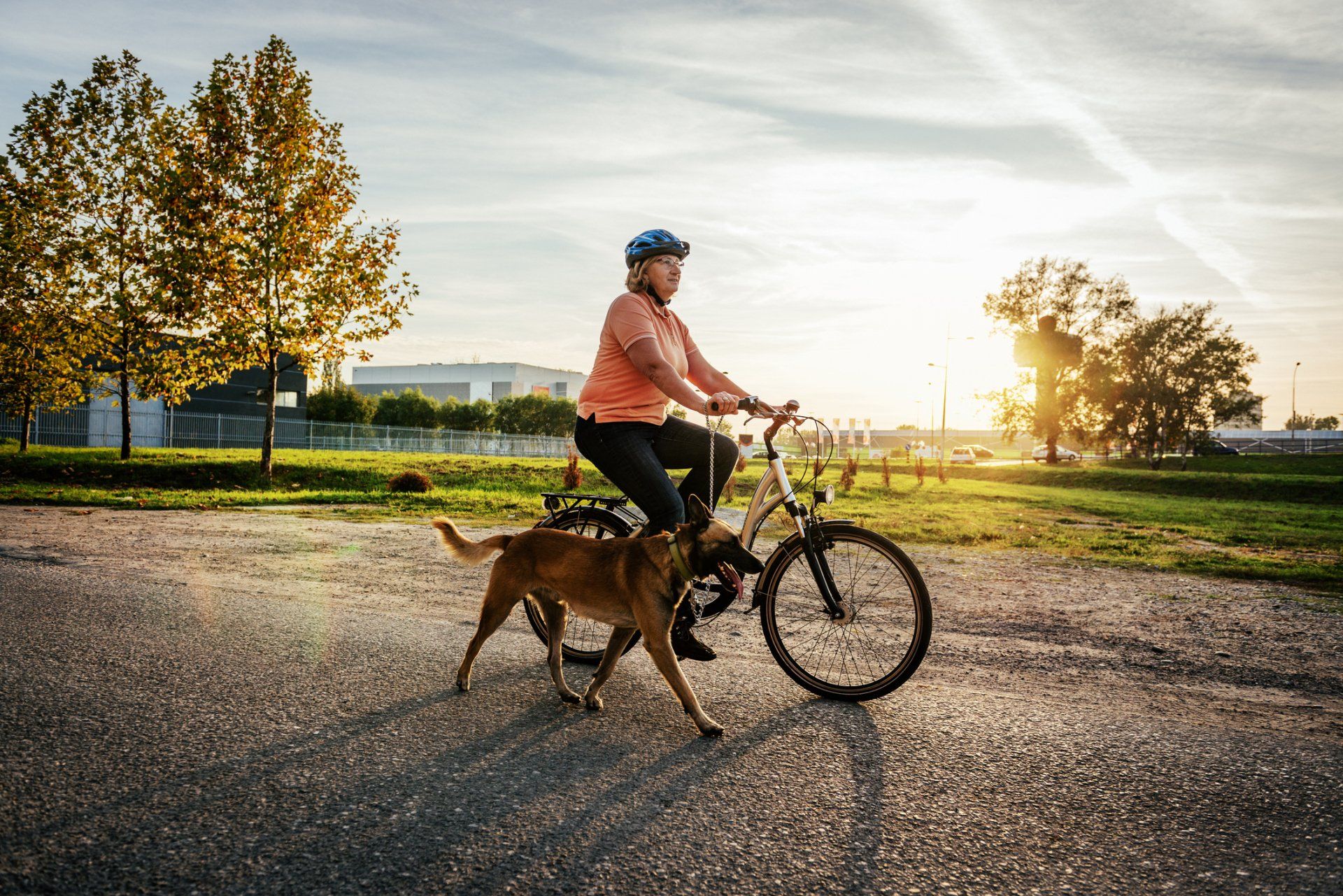 Woman Biking With Dog — Peachtree City, GA — Good Dog Happy Owner Dog Training LLC.