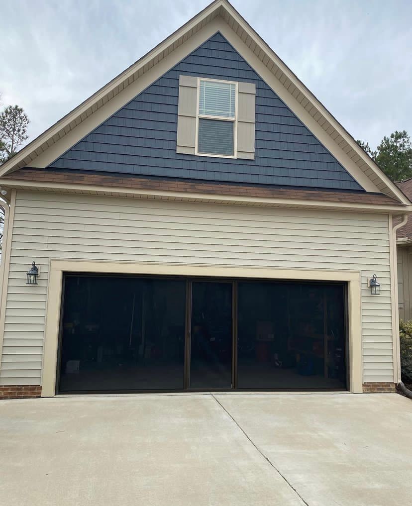 A garage with a blue roof and a window