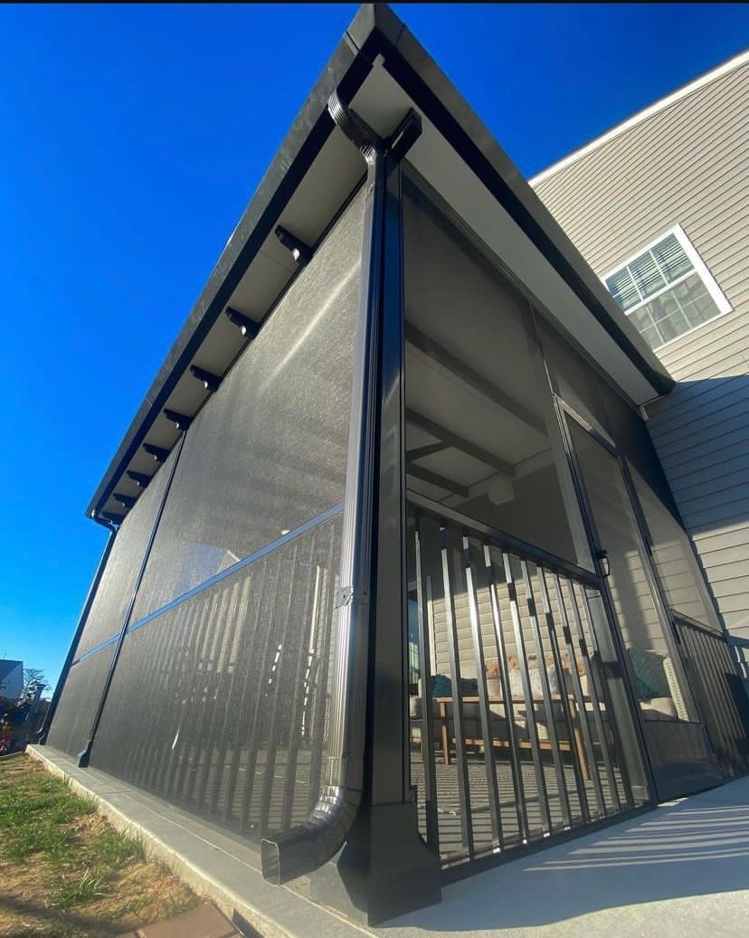 A screened in porch with a blue sky in the background