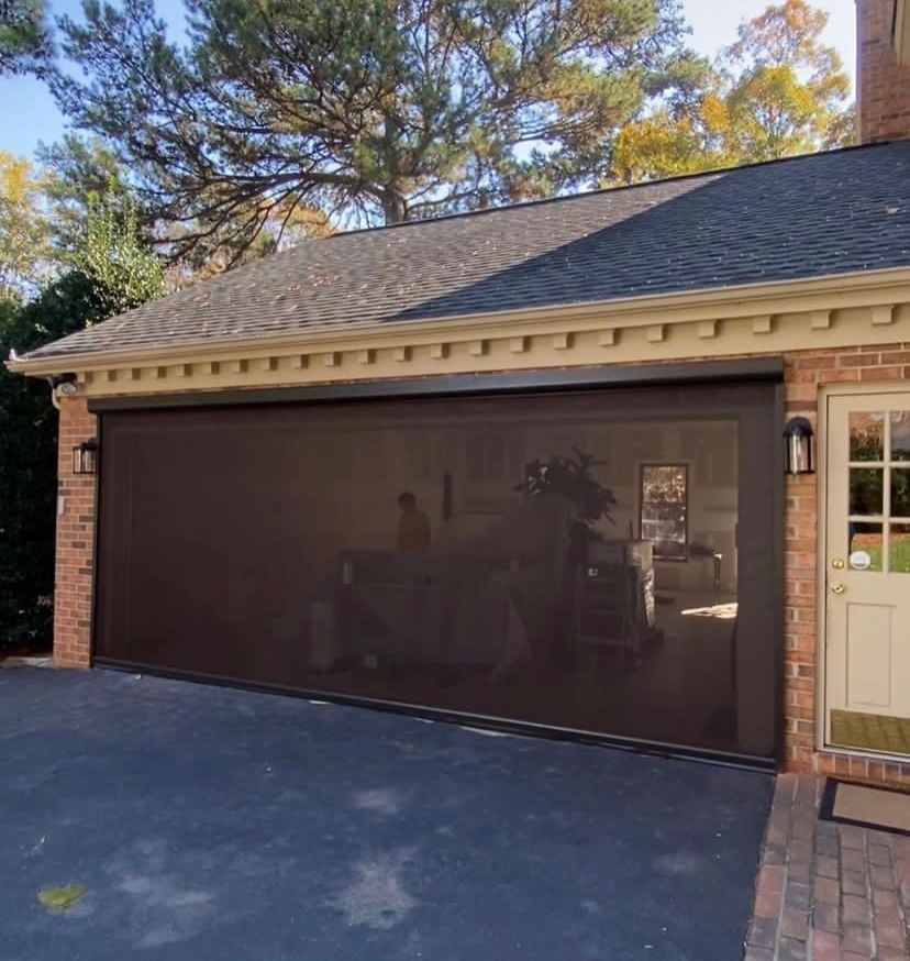 A brick garage with a large glass garage door