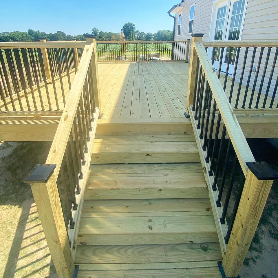 A wooden deck with stairs leading up to it