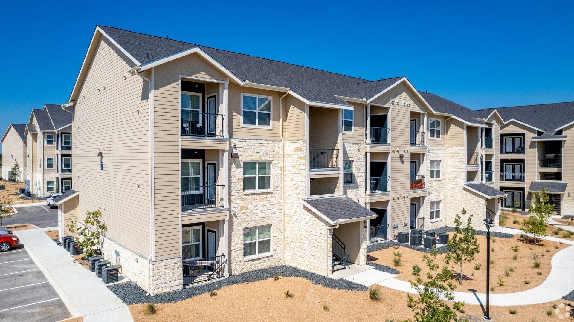 A large apartment building with a lot of windows and balconies.