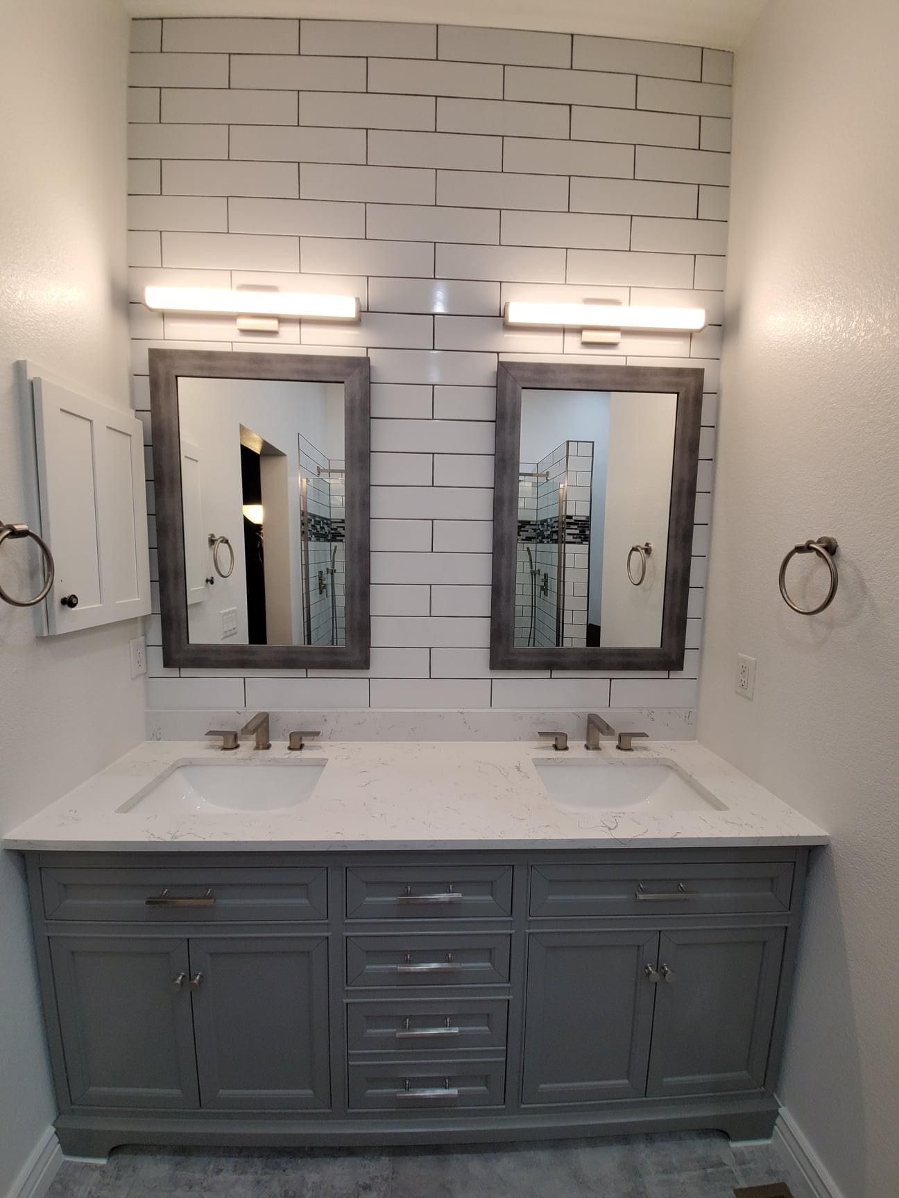 A bathroom with two sinks and two mirrors.