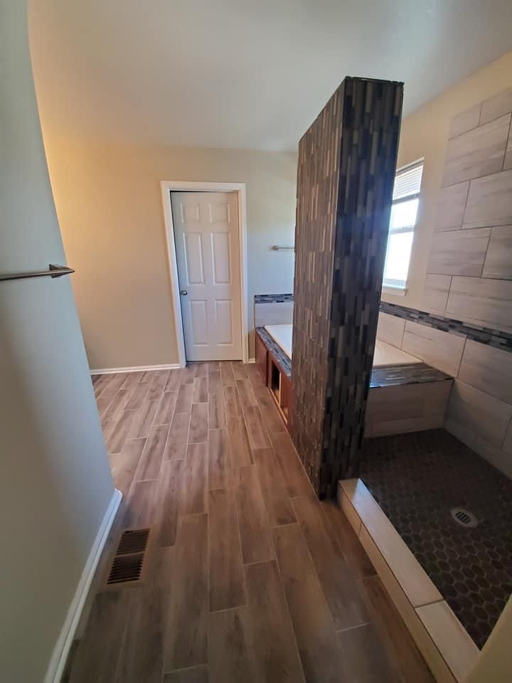 A bathroom with a walk in shower and a bathtub.