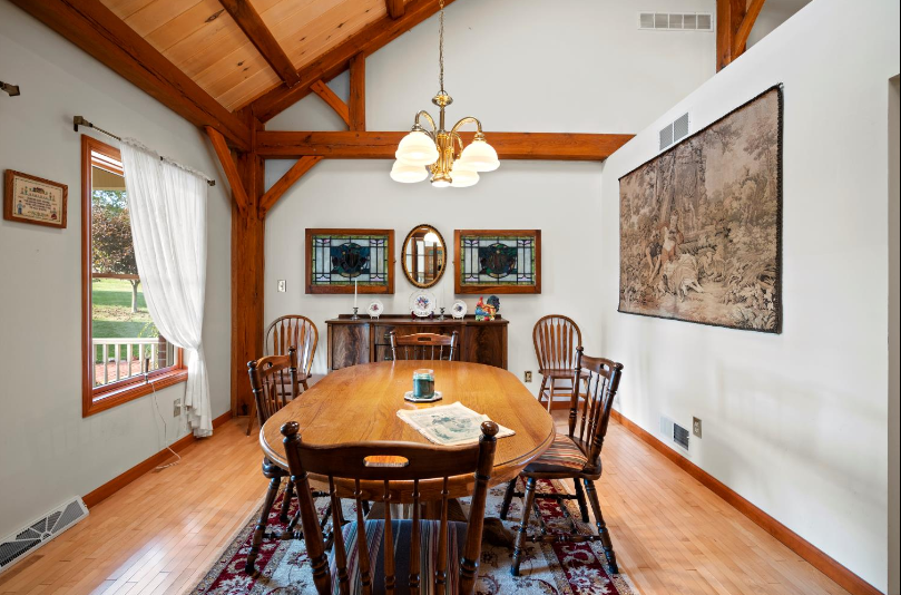 A dining room with a long wooden table and chairs